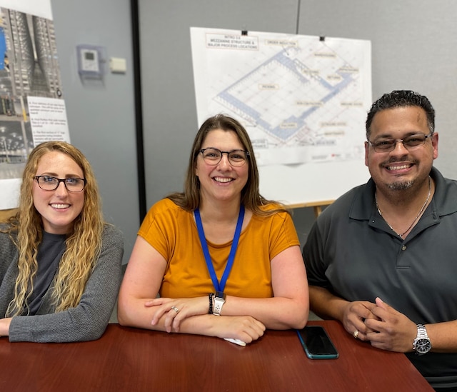 Group of people smiling in a break room